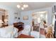 Open-concept living room featuring hardwood floors, comfortable seating, and views into the dining area and kitchen at 715 Barlang Cir, Fuquay Varina, NC 27526