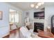 Bright living room features a fireplace, plush seating, and open access to the dining area at 715 Barlang Cir, Fuquay Varina, NC 27526