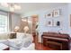 Bright living room showcasing wood floors, modern lighting, comfortable seating, and a piano at 715 Barlang Cir, Fuquay Varina, NC 27526