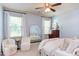 Bright main bedroom with large windows, ceiling fan, and a stylish decor at 715 Barlang Cir, Fuquay Varina, NC 27526