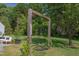 Charming backyard with a unique hanging swing, surrounded by lush greenery for a peaceful outdoor retreat at 715 Barlang Cir, Fuquay Varina, NC 27526