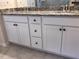 Bathroom featuring double sinks with granite counters and white cabinets at 718 Colby Pl, Durham, NC 27713