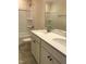 Well-lit bathroom with double vanity and shower-tub combination at 718 Colby Pl, Durham, NC 27713