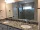 Bathroom featuring double sinks with granite counters and a glass shower at 718 Colby Pl, Durham, NC 27713