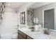 Well-lit bathroom with double sinks, granite countertops, and modern fixtures at 718 Colby Pl, Durham, NC 27713