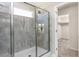 Modern bathroom with a glass-enclosed shower and convenient walk-in closet access at 718 Colby Pl, Durham, NC 27713