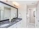 Elegant bathroom featuring double sinks, granite countertops, and modern fixtures at 718 Colby Pl, Durham, NC 27713