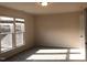Sunlit bedroom showcasing new carpeting and a view of the outdoors from the multiple, large windows at 718 Colby Pl, Durham, NC 27713
