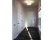 Hallway features wood floors, white doors and trim, with natural light filtering through the window at 718 Colby Pl, Durham, NC 27713