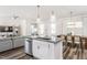 Open-concept kitchen with stainless appliances, granite countertops, and breakfast bar at 718 Colby Pl, Durham, NC 27713