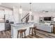 Modern kitchen boasts stainless appliances, granite counters, stylish pendant lighting and bar stool seating at 718 Colby Pl, Durham, NC 27713