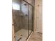 Modern tiled shower with glass door and chrome fixtures in the updated bathroom at 718 Colby Pl, Durham, NC 27713