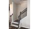 Elegant staircase with wood railing and wrought iron spindles leads to upper level at 718 Colby Pl, Durham, NC 27713