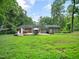 Expansive backyard with a deck featuring a hot tub, patio furniture, and ample space for outdoor activities at 725 Van Thomas Dr, Raleigh, NC 27615