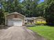Charming home with a two-car garage and a beautifully landscaped front yard at 725 Van Thomas Dr, Raleigh, NC 27615