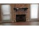 Close-up of a stone fireplace with hearth, complemented by natural light from nearby windows at 725 Van Thomas Dr, Raleigh, NC 27615