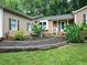 Inviting front entrance with manicured landscaping leading to the front porch of a ranch-style home at 725 Van Thomas Dr, Raleigh, NC 27615