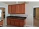 Eat-in kitchen featuring wooden cabinetry and views into an adjoining room at 725 Van Thomas Dr, Raleigh, NC 27615