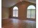 Bright living room featuring vaulted ceilings, hardwood floors, and large windows at 725 Van Thomas Dr, Raleigh, NC 27615