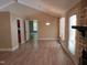 Living room with fireplace and view into the kitchen, showcasing an open floor plan and natural light at 725 Van Thomas Dr, Raleigh, NC 27615