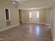 Bright living room with wood floors, neutral paint, ceiling fan, and ample natural light at 725 Van Thomas Dr, Raleigh, NC 27615