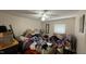 A bedroom filled with clutter, including clothing, boxes, and furniture, needs some attention to organize at 7312 Ray Rd, Raleigh, NC 27613