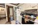View of kitchen with white cabinets, appliances, and tiled backsplash, ensuring a functional and stylish area at 7312 Ray Rd, Raleigh, NC 27613