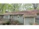 Back view of roof requiring maintenance, covered with leaves and damage from weather, from a single-story home at 7312 Ray Rd, Raleigh, NC 27613