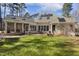 Exterior backyard view of a two-story home with solar panels and a sunroom at 7420 Heartland Dr, Wake Forest, NC 27587