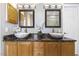Bathroom with double sinks, marble countertop, and warm lighting at 7420 Heartland Dr, Wake Forest, NC 27587