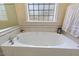 Bathroom with large bathtub and decorative window at 7420 Heartland Dr, Wake Forest, NC 27587