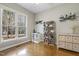 Cozy bedroom features hardwood floors, a bright window, and stylish decor at 7420 Heartland Dr, Wake Forest, NC 27587