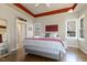 Bedroom with wood floors, bright windows, and ensuite entrance at 7420 Heartland Dr, Wake Forest, NC 27587