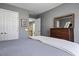 Bedroom features soft carpet, grey walls, and a dark wood dresser at 7420 Heartland Dr, Wake Forest, NC 27587