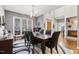 Elegant dining room with hardwood floors, a statement rug, and backyard view at 7420 Heartland Dr, Wake Forest, NC 27587