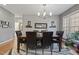 Bright dining room with a wooden table, leather chairs, and modern light fixture at 7420 Heartland Dr, Wake Forest, NC 27587