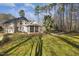 Exterior view of a home with a sunroom, landscaping, and a paved backyard area at 7420 Heartland Dr, Wake Forest, NC 27587