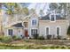 Beautiful two-story home with white brick exterior and well-maintained landscaping at 7420 Heartland Dr, Wake Forest, NC 27587