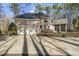 Two-story home with brick exterior, attached garage, solar panels, and beautiful landscaping at 7420 Heartland Dr, Wake Forest, NC 27587