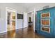 Hallway with hardwood floors, a decorative cabinet, and multiple rooms at 7420 Heartland Dr, Wake Forest, NC 27587