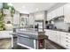 Lovely kitchen showcasing white cabinets, stainless steel appliances, mosaic backsplash, and large island with seating at 7420 Heartland Dr, Wake Forest, NC 27587