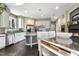 Well-lit kitchen with white cabinets, stainless steel appliances, a kitchen island, and a cozy fireplace at 7420 Heartland Dr, Wake Forest, NC 27587