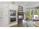 Kitchen area including built-in ovens, a stone fireplace, a dining area, and views to the outside at 7420 Heartland Dr, Wake Forest, NC 27587