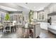 Bright kitchen with a dining area, island, white cabinets, and views to the outside living spaces at 7420 Heartland Dr, Wake Forest, NC 27587