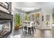 Kitchen area with stone floors, fireplace and dining table with lots of natural light at 7420 Heartland Dr, Wake Forest, NC 27587