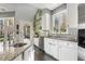 Stylish kitchen with white cabinets, stainless steel appliances, granite countertops, and mosaic tile backsplash at 7420 Heartland Dr, Wake Forest, NC 27587