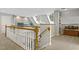Second story landing features carpeted floor, skylights, and a wood railing at 7420 Heartland Dr, Wake Forest, NC 27587