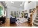 Bright living room with high ceilings, large windows, fireplace, and staircase at 7420 Heartland Dr, Wake Forest, NC 27587