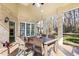 Sunroom with brick wall, ceiling fan, tile floor, and backyard views at 7420 Heartland Dr, Wake Forest, NC 27587