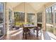 Sunroom with brick accents, vaulted ceiling, tile floor, and backyard views at 7420 Heartland Dr, Wake Forest, NC 27587